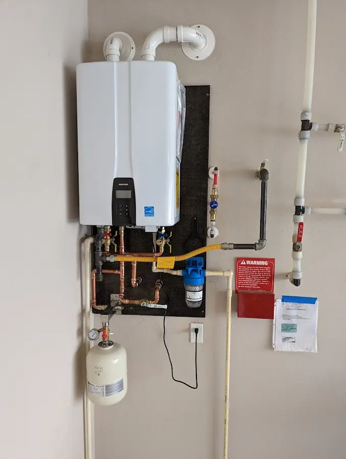 Professional plumber installing copper piping in a Forest City home